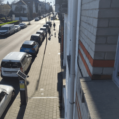 a row of cars are parked on the side of the road next to a parking meter