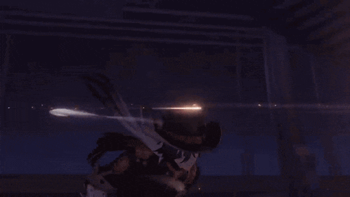 a man in a cowboy hat is standing in a dark room holding a gun .