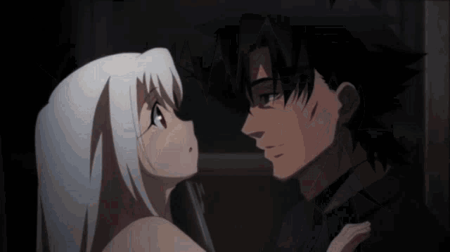 a man and a woman are looking at each other