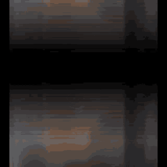 a blurred image of a dark room with a few lights on
