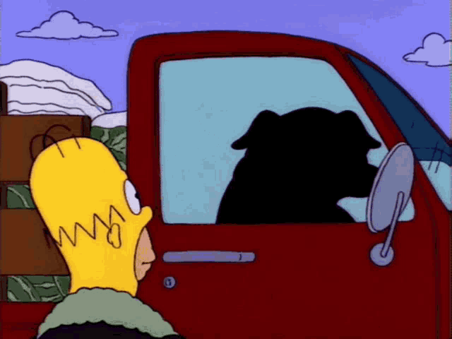 a cartoon of homer simpson looking out of a red truck