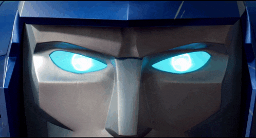 a close up of a transformer 's face with blue eyes