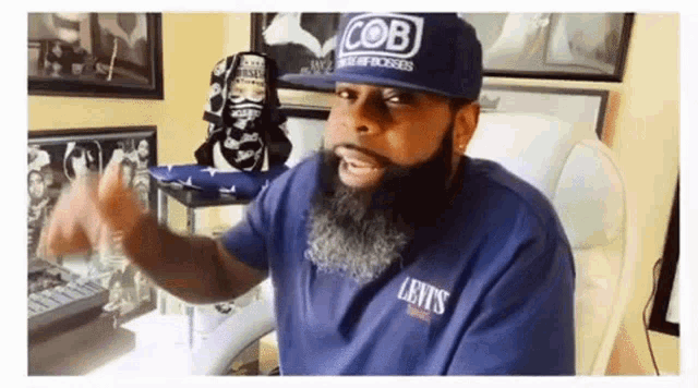 a man with a beard is wearing a hat that says cob on it
