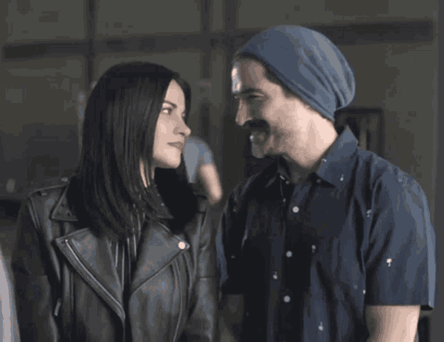 a man and a woman are standing next to each other