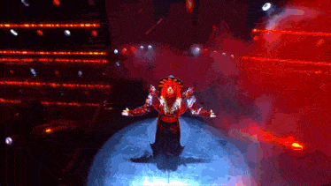 a person in a red costume is standing on a stage