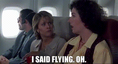 a group of people are sitting on an airplane and one of them is saying `` i said flying oh . ''