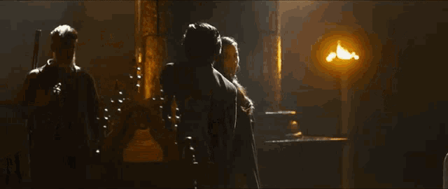 a man and woman are standing in a dark room