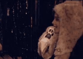 a woman wearing a furry hat with a paw on it