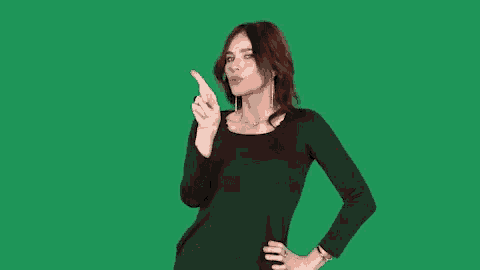 a woman in a black dress is making a rude gesture