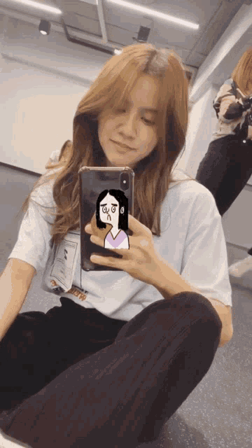 a woman is taking a picture of herself in a mirror with her phone