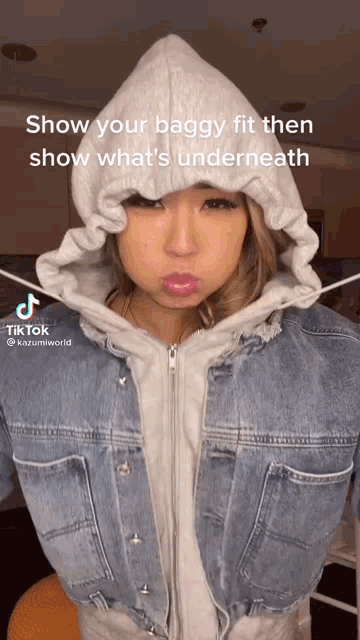 a woman is wearing a denim jacket with a hood and a tiktok caption