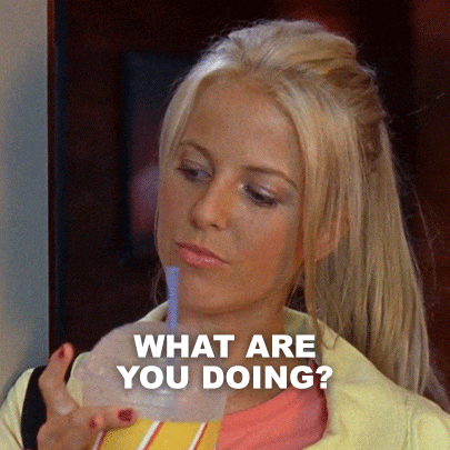 a blonde woman drinking from a plastic cup with the words what are you doing written below her
