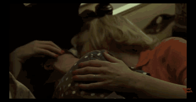 a close up of a woman 's hand on another woman 's stomach