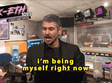 a man says i 'm being myself right now in front of a sign that says keith 101.1
