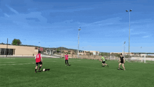 a group of soccer players are playing on a field and one of them has the number 21 on their jersey