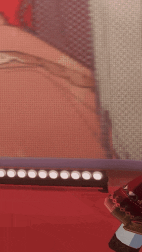 a cartoon character is standing on a red carpet in front of a screen