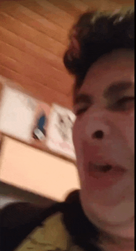 a close up of a man 's face with his mouth open