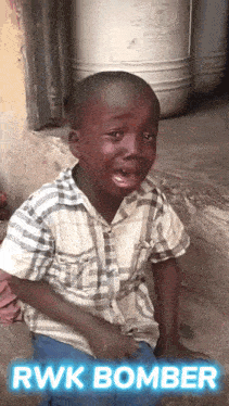 a young boy is crying and the words rwk bomber are on the bottom