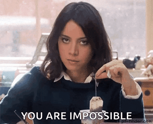 a woman is holding a tea bag in her hand and says you are impossible