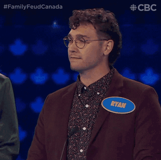 a man wearing a name tag that says ryan