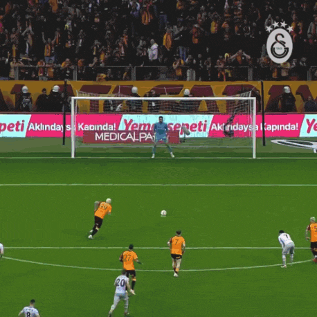 a soccer game is being played in front of a banner that says medical park