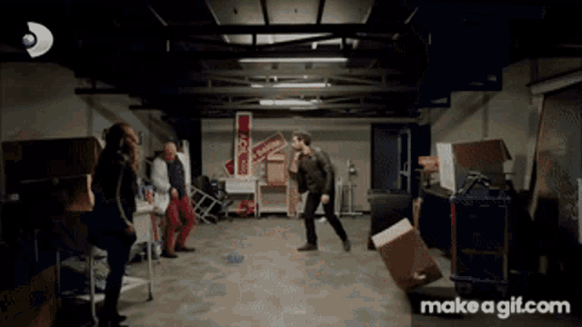 a group of people are standing in a room with a sign that says coca cola on it