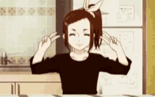 a girl in a black shirt is brushing her hair in front of a refrigerator .