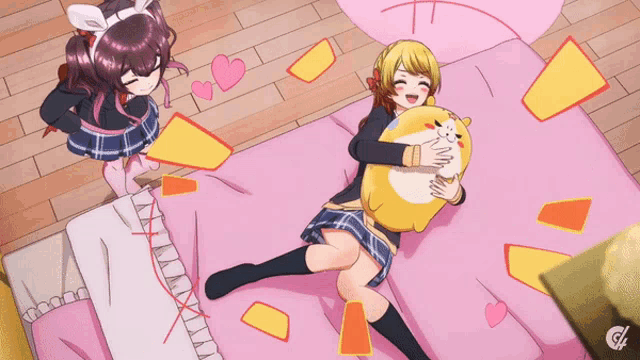 a girl laying on a bed holding a stuffed animal and another girl standing behind her