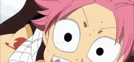 a close up of a cartoon character with pink hair and white eyes making a funny face .