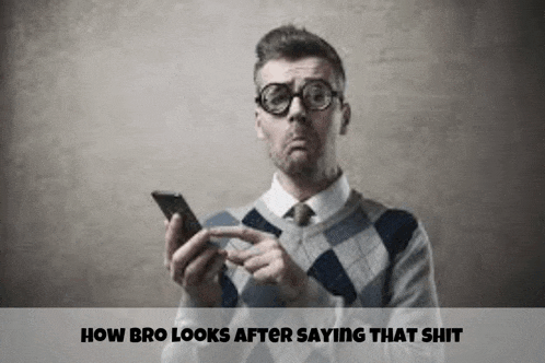 a man wearing glasses is holding a cell phone in his hand .
