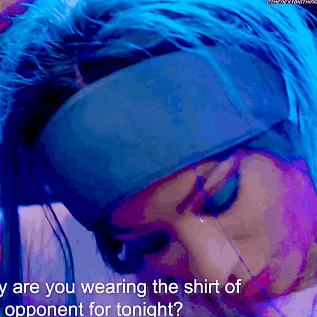 a woman wearing a blue headband is being asked " are you wearing the shirt of opponent for tonight "