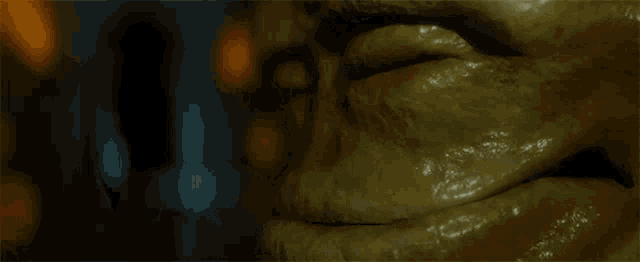 a close up of a cartoon character 's face with a glowing eye and teeth .