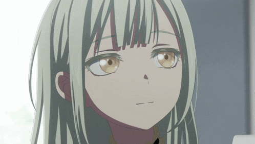 a close up of a girl 's face with a slight smirk on her face