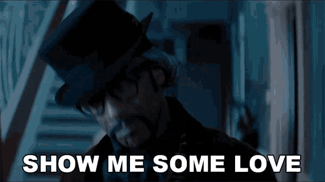a man in a top hat says show me some love in a dark room