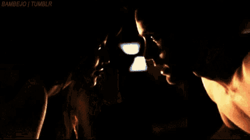 a man is holding a pair of scissors in his hands .