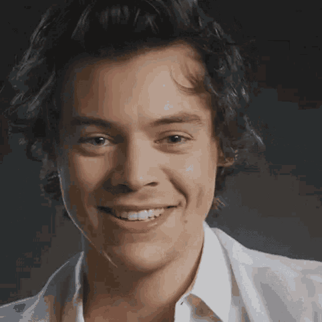 a close up of a man 's face with a smile on it .