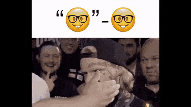 a man wearing glasses and a hat is being congratulated by a crowd of people