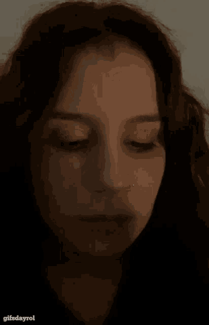 a close up of a woman with her eyes closed