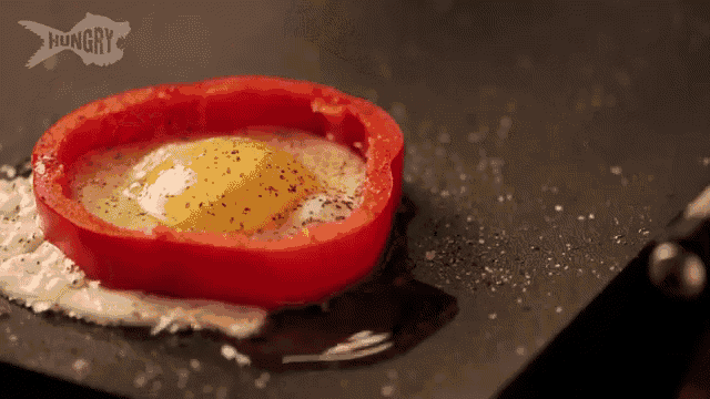 a hungry logo can be seen behind a fried egg in a tomato