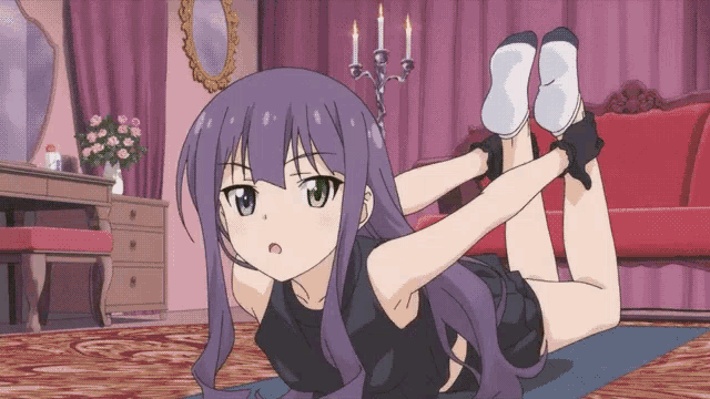 a girl with purple hair is doing yoga on a mat