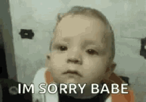 a baby is making a funny face and says `` im sorry babe '' .