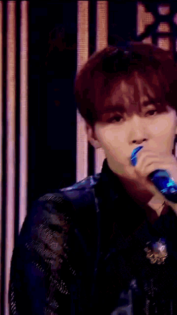 a close up of a person holding a microphone