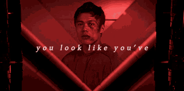 a man in a red room with the words you look like you 've