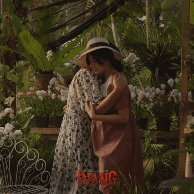 two women hugging each other with the word inang on the bottom
