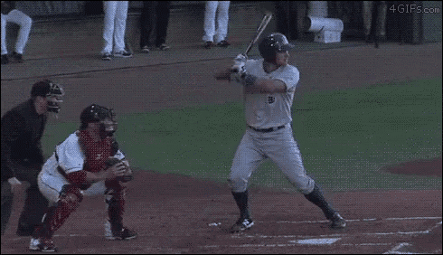 a baseball player with the number 40 on his jersey is swinging a bat at a ball .