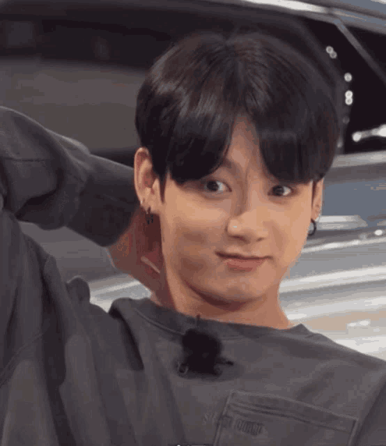 a close up of a person wearing a sweater that says ' super junior ' on the pocket