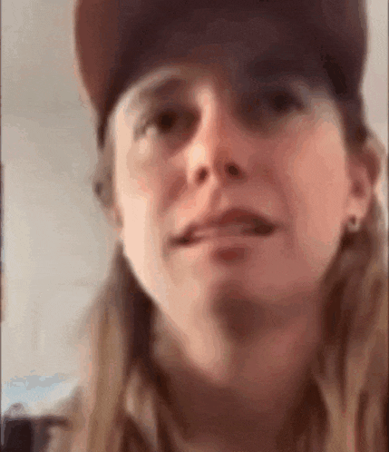 a close up of a woman wearing a baseball cap .