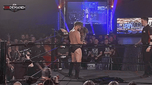 two men wrestling in a ring with the word demand on the bottom