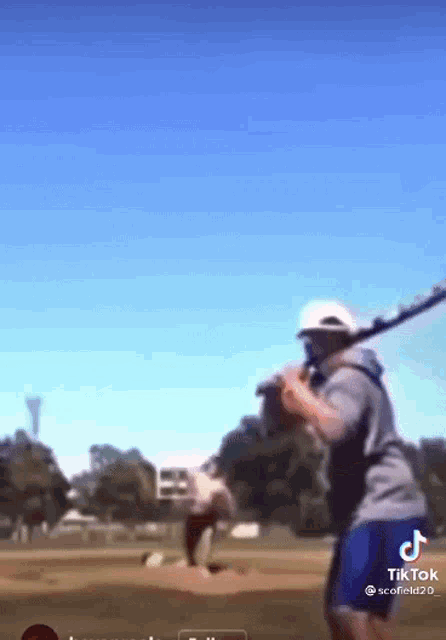 a man is swinging a baseball bat on a field with a tiktok watermark