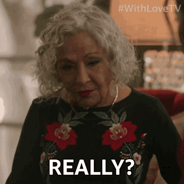 an older woman says really in a floral shirt